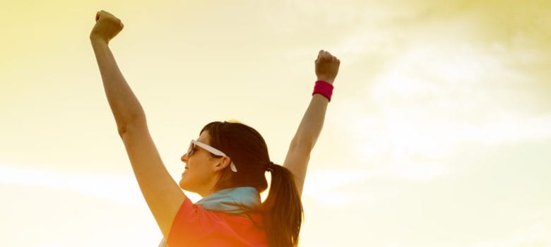 Woman with arms upraised victoriously