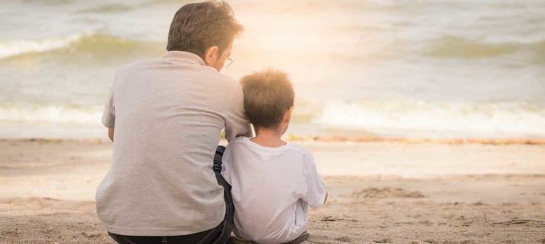 father and son on the beach